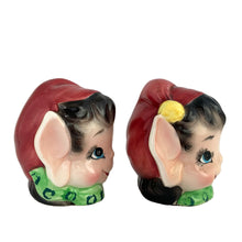 Load image into Gallery viewer, Vintage mid-century hand painted ceramic pixie elf salt and pepper shakers. These Christmas themed shakers are nicely painted in red, green, white black and yellow. Crafted by Lefton, Japan, 1950s. These highly collectible kitschy shakers are the perfect accent for your Christmas holiday decor!

The shakers are in excellent condition, no chips/cracks/repairs. One is missing the cork. Marked 6981 Japan.

Shakers measures approximately 2 3/4 x 2 1/4 x 3 inches
