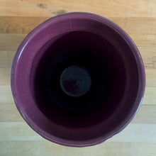 Load image into Gallery viewer, Vintage art deco plum stoneware vase featuring repeating columns of stacked palm leaves. Crafted by Robinson Ransbottom Pottery Co., USA, 1930s. A beautiful piece to add to your art pottery collection!

In as found condition, hairline crack at the rim (see photos), no chips/repairs. Typical manufacturing glaze pops. Unmarked.

Measures 6 1/4 x 10 1/4 inches
