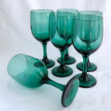 Load image into Gallery viewer, Set of eight vintage Premiere dark green water goblets or wine glasses. Crafted by Libbey Glass, USA, 1997 - 1998. The colour is absolutely fabulous and reminiscent of the deep dark delicious forest.

In excellent condition, no chips.

Measures 2 3/4 x 7 1/4 inches

Capacity 11 ounces
