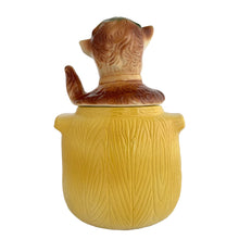 Load image into Gallery viewer, Adorable vintage, mid-century era Pup in the Pot ceramic cookie jar. Crafted by American Bisque, 1950s. A delightful addition to your cookie jar collection and kitchen decor!

In as found vintage condition, no chips, hairline fracture to the base, normal crazing commensurate with age.

Measures 6 1/2 x 6 x 11 1/2 inches
