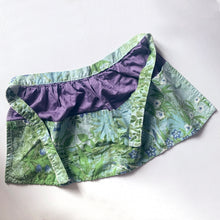 Load image into Gallery viewer, Beautifully hand made vintage fabric apron with pockets. The gathered body of the apron is made in purple fabric with the band and pockets in a pretty robin&#39;s egg blue with white and green flowers.  In excellent condition, free from rips/stains.  The band measures 42 inches, body measures 25 1/2 x 13 inches
