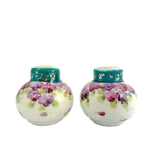 Load image into Gallery viewer, Vintage Nippon round white&nbsp; Salt and Pepper Shakers featuring a and Teal collar with gold scrolls with purple violets. Crafted in Japan, early 20th century. A pretty pair of shakers to elevate your tablescape.  In excellent vintage condition, no chips. There is one cork and the other has a plastic stopper.  Measures 2 x 2 1/4 inches
