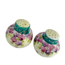 Load image into Gallery viewer, Vintage Nippon round white&nbsp; Salt and Pepper Shakers featuring a and Teal collar with gold scrolls with purple violets. Crafted in Japan, early 20th century. A pretty pair of shakers to elevate your tablescape.  In excellent vintage condition, no chips. There is one cork and the other has a plastic stopper.  Measures 2 x 2 1/4 inches
