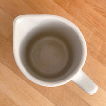 Load image into Gallery viewer, Vintage vitrified stoneware pottery handled pitcher, embossed with the RCAF King’s Tudor logo. Crafted by Medalta Pottery, Canada, 1950s. A nice piece of utilitarian pottery made for the Royal Canadian Air Force.

In excellent condition, no chips/cracks.

Measures 3 7/8 x 5 1/4 inches
