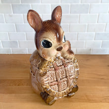 Load image into Gallery viewer, Adorable vintage, mid-century era anthropomorphic ceramic rabbit cookie jar. Crafted by Royal Sealy, Japan, 1950s. A delightful addition to your cookie jar collection and kitchen decor!

In as found vintage condition, with 2 chips to the rim of the lid and a well executed repair to one ear, see photos. No cracks and typical age-related crazing.

Measures 6 x 7 1/4 x 13 1/4 inches
