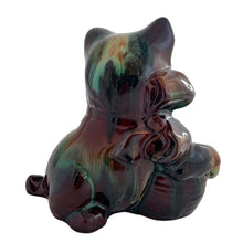 Load image into Gallery viewer, Playful vintage rainbow drip glazed redware ceramic cat figurine with bow and a ball of yarn. Crafted by CCC (Canadian Ceramic Craft, Canada, circa 1960s. A sweet piece to add to your CCC or cat collection. In excellent condition, free from chips/cracks/repairs. Measures 6 3/8 x 4 x 6 inches
