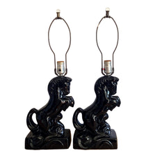 Load image into Gallery viewer, Fabulous pair of vintage rearing black horse ceramic table lamps with brass harps and clear glass marble finials. 1960 or 1970s era judging by the cords and straight pronged plug. These lamps bring all the retro vibes to your home decor!

Both lamps are in excellent condition, no chips/cracks/repairs. New felt on the bottom of each lamp.

Measurements: 7 1/2 x 5 x 12 inches (23 1/2 inches to top of finial)

Suitable for a 9 or 10 inch shade
