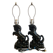 Load image into Gallery viewer, Fabulous pair of vintage rearing black horse ceramic table lamps with brass harps and clear glass marble finials. 1960 or 1970s era judging by the cords and straight pronged plug. These lamps bring all the retro vibes to your home decor!

Both lamps are in excellent condition, no chips/cracks/repairs. New felt on the bottom of each lamp.

Measurements: 7 1/2 x 5 x 12 inches (23 1/2 inches to top of finial)

Suitable for a 9 or 10 inch shade
