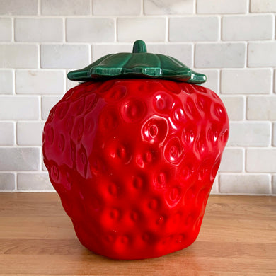 Rare vintage retro figural red strawberry cookie jar, topped with green lid. Crafted by McCoy Pottery, USA, 1970s. A good sized stoneware canister for a large batch of cookies that will look great as part of your kitchen decor!

In vintage condition, no chips/cracks/repairs, scuffing at the rim of the strawberry. Maker's mark on bottom.

Measures 7 1/4 x 9 3/4 inches