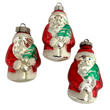 Load image into Gallery viewer, Stunning vintage red and silver figural mercury glass Santa Claus holding a green tree, Christmas tree ornament. Made in Germany. Dress up your holiday tree or display with these beautiful hand crafted ornaments.

In vintage condition. One marked East Germany, one marked Made in GDR, one unmarked.

Measures 3 1/2 inches
