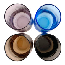 Load image into Gallery viewer, Set of four vintage multi-coloured roly poly juice or cocktail glasses in blue, purple, orange and brown—each one a little burst of retro charm. Perfect for sipping morning juice, mixing craft cocktails, or simply displaying as colourful kitchen décor.

In excellent condition, no chips.

Measures 2 x 3 1/2 inches

Capacity 5 ounces
