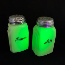 Load image into Gallery viewer, Vintage &quot;Roman Arch&quot; custard uranium glass salt and pepper shaker with the words Salt and Pepper in crisp black script. Produced by McKee Glass, USA, 1930 - 1951. These art deco beauties glow brilliantly under black light and will make a great addition to any vintage kitchen collection!
