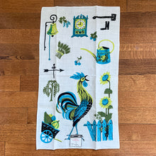 Load image into Gallery viewer, Stunning vintage mid-century era cream coloured linen tea towel featuring a hand printed rooster and farm graphics in shades of blue, green and black. An artful addition to your vintage or contemporary kitchen decor.  This piece is new old stock with original tag. In excellent condition. Made in Hungary.  Measures 17 x 29 inches   

