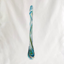 Load image into Gallery viewer, Catch some rays with this artfully hand blown art glass &quot;Rooted In Love&quot; clear raindrop  suncatcher swirled in shades of blue, purple and green. Produced by Alyssa Getz and Tom Cudmore of Tropical Iceberg Glass in Mississauga, Canada. Made with a looped top for ease of hanging.  In like new condition with original tags, free from chips/cracks.  Measures 1 3/8 x 10 3/8 inches
