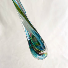 Load image into Gallery viewer, Catch some rays with this artfully hand blown art glass &quot;Rooted In Love&quot; clear raindrop  suncatcher swirled in shades of blue, purple and green. Produced by Alyssa Getz and Tom Cudmore of Tropical Iceberg Glass in Mississauga, Canada. Made with a looped top for ease of hanging.  In like new condition with original tags, free from chips/cracks.  Measures 1 3/8 x 10 3/8 inches
