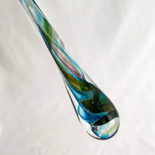 Load image into Gallery viewer, Catch some rays with this artfully hand blown art glass &quot;Rooted In Love&quot; clear raindrop  suncatcher swirled in shades of blue, purple and green. Produced by Alyssa Getz and Tom Cudmore of Tropical Iceberg Glass in Mississauga, Canada. Made with a looped top for ease of hanging.  In like new condition with original tags, free from chips/cracks.  Measures 1 3/8 x 10 3/8 inches
