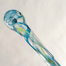 Load image into Gallery viewer, Catch some rays with this artfully hand blown art glass &quot;Rooted In Love&quot; clear raindrop  suncatcher swirled in shades of blue, purple and green. Produced by Alyssa Getz and Tom Cudmore of Tropical Iceberg Glass in Mississauga, Canada. Made with a looped top for ease of hanging.  In like new condition with original tags, free from chips/cracks.  Measures 1 3/8 x 10 3/8 inches
