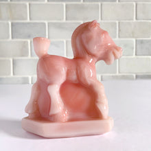 Load image into Gallery viewer, Vintage rosaline slag glass Oscar plug horse figurine. Originally designed and produced by Heisey Glass 1941 - 1946. Reproduction crafted with original mold by Fenton Art Glass, 1990. Marked with HCA 90 and Fenton logo. Only 1267 of the rosaline plug horses were made, making it highly collectible. This playful horse is perfect to start or add to your collection or to gift to the animal lover in your life! New old stock, in excellent condition, free from chips. Measures approximately 4 x 1 1/2 x 4 inches
