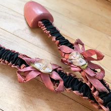 Load image into Gallery viewer, Vintage ladies wood and metal shoe stretchers in rose pink with pretty black and rose fabric covers. These feature wood ends between a flexible metal strap. Perfect to help your shoes retain their original shape. Circa 1950s  In good vintage condition with minor age-related wear.  Measures approximately 11 1/2 inches long
