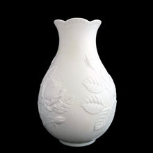 Load image into Gallery viewer, Vintage Rose white bisque flower vase, 635, featuring embossed roses and scalloped edge. Designed by M. Frey for Kaiser, Germany, 1980s. This delicate bottle shaped vase will look stunning in any setting!

In excellent condition, no chips/cracks/repairs. Maker&#39;s mark on bottom.

Measures 4 x 4 x 7 1/8 inches
