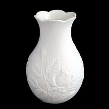 Load image into Gallery viewer, Vintage Rose white bisque flower vase, 635, featuring embossed roses and scalloped edge. Designed by M. Frey for Kaiser, Germany, 1980s. This delicate bottle shaped vase will look stunning in any setting!

In excellent condition, no chips/cracks/repairs. Maker&#39;s mark on bottom.

Measures 4 x 4 x 7 1/8 inches
