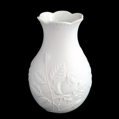 Vintage Rose white bisque flower vase, 635, featuring embossed roses and scalloped edge. Designed by M. Frey for Kaiser, Germany, 1980s. This delicate bottle shaped vase will look stunning in any setting!

In excellent condition, no chips/cracks/repairs. Maker's mark on bottom.

Measures 4 x 4 x 7 1/8 inches