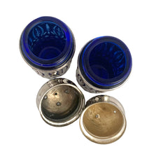 Load image into Gallery viewer, Vintage Avon &quot;Royal Sapphire Collection&quot; cobalt blue glass salt and pepper shakers with silver plated filigree sleeves.  In excellent condition, no chips to the glass. Wear to the lids, see photos.  Measures 1 1/2 x 4 inches
