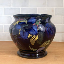 Load image into Gallery viewer, Vintage Royal Stanley Ware cobalt blue redware pottery jardiniere or planter, hand painted with a Clematis vine in shades of blue, purple, yellow, pink and green. Crafted by Colcolough &amp; Co., England, 1919-1931. A lovely addition to your home&#39;s decor.

In excellent condition, no chips/cracks/repairs. Maker&#39;s mark on bottom.

Measures 5 1/2 x 5 inches
