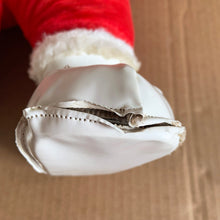 Load image into Gallery viewer, This rare adorable vintage mid-century era large rubber faced Santa Claus stuffed toy features a smiling side eyed face, a sheared velour red suit bordered with white plush trim, black vinyl belt, white velour hands, white vinyl-type blanket stitched boots. Crafted by the Rushton Company, USA, 1950s. A wonderful piece of Christmas nostalgia!

In as found vintage condition. The stitching on the boots have been repaired and could benefit from additional repair. Original tag.

Measures 13 1/2 x 24 1/2 inches
