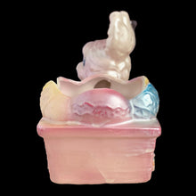 Load image into Gallery viewer, Side view of vintage Rubens Originals bunny planter displaying pink, blue, yellow and white lustreware glaze finish

