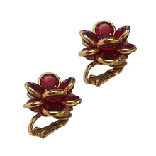 Load image into Gallery viewer, Angled view of 1980s Swarovski faceted ruby red crystal flower clip-on earrings showing dimensional floral design and gold-tone settings
