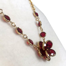 Load image into Gallery viewer, Vintage Swarovski necklace showing ruby red crystal flower pendant and graduated crystal accents on gold-tone chain

