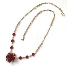 Load image into Gallery viewer, These elegant vintage necklace feature meticulously faceted ruby red crystal blooms mounted in warm gold-tone settings. Crafted by Swarovski, Austria, 1980s. The flower catches light beautifully while maintaining that coveted vintage aesthetic. Perfect for adding a touch of refined color and sparkle to any occasion. Wear them alone or paired with other vintage pieces for effortless glamour.

In excellent vintage condition.

Measures 19 1/2 inches
