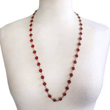Load image into Gallery viewer, This stunning vintage opera-length necklace, features sparkly ruby red faceted cut crystals set in gold-toned metal, barrel clasp. Crafted by Swarovski, Austria, 1980s. Wear it alone or paired with other vintage pieces for effortless glamour. A beautiful example of classic Swarovski craftsmanship, this piece offers luxury sparkle at a fraction of the cost of fine gemstones. Perfect for collectors, romantic outfits, or anyone who loves classic crystal jewelry with timeless appeal.
