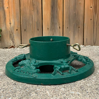 Get ready to put up the Christmas tree using this gorgeous cast iron stand in hunter green, decorated with Santa Claus in his sleigh with reindeer! The perfect addition to your vintage or modern Christmas decor.

In used vintage condition.

Dimensions: 14 inch diameter, reservoir measures 6 1/4 x 4 1/4 inches
