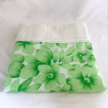 Load image into Gallery viewer, Dress your bed in these retro green and white floral &quot;Serenity&quot; patterned pillowcases. Each piece is trimmed with a white edge banded with eyelet lace. Manufactured by Wabasso, Canada, circa 1970s. Create a restful slumber with these beautifully designed and well-made linens!  In excellent condition, free from stains/tears. Colours are vibrant.  Two pillowcase measures 34 x 20 3/4 inches
