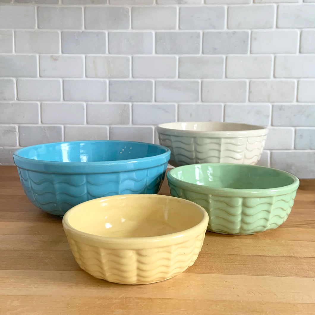 Vintage set of four ceramic 308 mixing bowls, with an exterior pattern of horizontal waves in yellow, mint green, white and robin's egg blue. Crafted by Robinson Ransbottom Pottery Co., USA, 1960s. A beautiful set to add to your kitchen art pottery collection!

In excellent condition, no chips/cracks/repairs, manufacturer's glaze pops. Maker's marks, number 308.