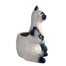 Load image into Gallery viewer, Adorable vintage mid-century era Siamese cat ceramic planter. Crafted by Elbro, Japan, 1950s. Perfect for a small houseplant, air plant or repurpose to hold cat treats or accessories.

In excellent condition, no chips/cracks. Maker&#39;s mark on the bottom.

Measures 5 1/2 x 5 x 7 inches
