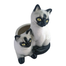 Load image into Gallery viewer, Adorable vintage mid-century era Siamese cat ceramic planter. Crafted by Elbro, Japan, 1950s. Perfect for a small houseplant, air plant or repurpose to hold cat treats or accessories.

In excellent condition, no chips/cracks. Maker&#39;s mark on the bottom.

Measures 5 1/2 x 5 x 7 inches
