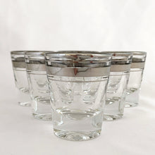 Load image into Gallery viewer, Set of six vintage mid-century era silver banded and rimmed shot glasses. Libbey Glass, USA, 1960s. Add some Hollywood Regency glam to your barware collection with these beauties!

Good vintage condition, no chips, minor wear to the silver.

Measures 1 7/8 x 2 1/4 inches

Capacity 1 ounce
