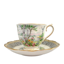 Load image into Gallery viewer, Vintage &quot;Silver Birch&quot; porcelain teacup and saucer. Crafted by Royal Albert, England, 1935 - 1945. This beautiful pattern consists of lakeside woodland scene of birch trees and colourful flowers surrounded with a border of rustic gray and cream, rimmed in gold gilt. In excellent condition, free from chips/cracks/repairs.
