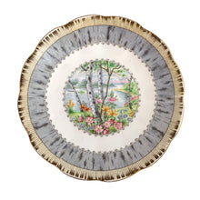 Load image into Gallery viewer, Vintage &quot;Silver Birch&quot; porcelain teacup and saucer. Crafted by Royal Albert, England, 1935 - 1945. This beautiful pattern consists of lakeside woodland scene of birch trees and colourful flowers surrounded with a border of rustic gray and cream, rimmed in gold gilt. In excellent condition, free from chips/cracks/repairs.
