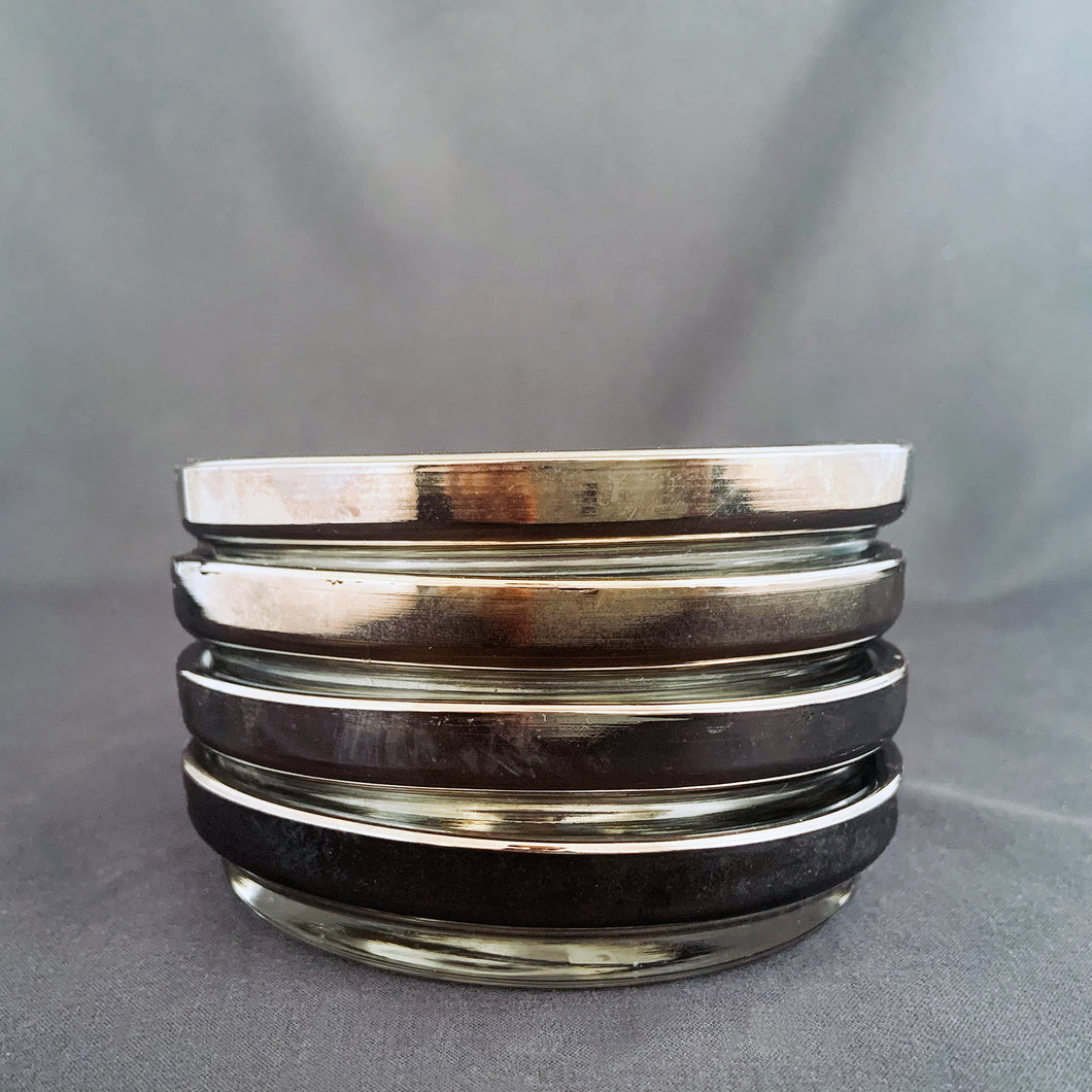 Set of four vintage silver fade stackable glass coasters. Crafted by Queen's Vitreon Lustreware, USA, circa 1960s. A great addition to your barware collection! In excellent condition, free from chips. Measures 3 3/4 x 3/4 inches