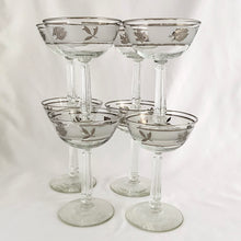 Load image into Gallery viewer, These vintage mid-century glasses certainly put the &quot;glam&quot; in glamourous. The pattern is called  &quot;Silver Leaf&quot; which is a band of silver leaves set on a frosted band on glass bordered by more silver. The stem replicates a delicate grecian style column. These will make a stunning addition to your barware!  Produced by the Libbey Glass Company in the USA, produced between 1953 - 1978.  In excellent condition, free form chips/cracks/wear.   Measures 3-3/4&quot; x 5-5/8&quot;
