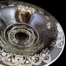 Load image into Gallery viewer, This striking vintage clear glass console bowl with silver overlay is a simply stunning. The silver overlay was produced by the Silver City Glass Co., circa 1940s. This generous sized console bowl. It will elevate any occasion to a special one. A beautiful addition to any collection and a lovely way to add a touch of vintage charm to your home. Would make a spectacular wedding gift! In excellent condition, free from chips, silver is intact. Measures 12 1/4 x 4 1/2 inches
