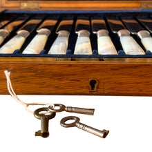 Load image into Gallery viewer, Antique EPNS silver plate fork and knife set featuring Mother-of-Pearl handles with locking royal blue velvet lined golden oak wood box, includes 3 keys. Crafted by Harrison Brothers &amp; Howson, England, circa 1890s. A gorgeous set of cutlery perfect for dessert and fruit service.

In excellent vintage condition, freshly polished. Phillips Montreal appraisal certificate included.

Fork measures 6 1/8 inches
Knife measures 7 1/2 inches
Box measures 11 1/4 x 9 1/4 inches
