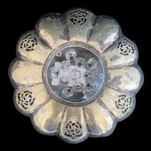Load image into Gallery viewer, This lovely vintage silver plated flower vessel is ornately engraved with florals, decorative swirls, leaves and pierced details. Crafted by Essay Silversmiths, Canada 1950s. With the glass flower frog you&#39;ll be able to create a beautiful centrepiece.

Silver vessel is in vintage condition. Glass frog in excellent condition, no chips.

Vessel measures 6 3/8 x 2 1/4 inches (interior bowl diameter of 2 1/2 inches)

Glass frog measures 3 1/4 x 1 3/8 inches

