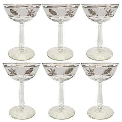 Vintage mid-century Silver Leaf champagne coupe or martini glass featuring silver leaves set on a frosted band, silver bands, grecian column stem. Crafted by Libbey Glass, USA, 1953 - 1978. These put the 