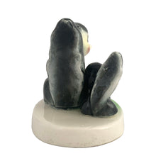 Load image into Gallery viewer, Vintage mid-century kitsch ceramic figures of a skunk mama and baby with a sweet pink flower on a stand. Crafted in Japan, circa 1950s. An adorable figurine to add to your mid-century animal figurine collection.  In excellent condition, no chips/cracks/repairs.  Measures 3 1/2 x 2 5/8 x 3 inches
