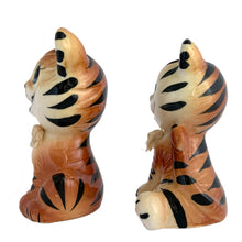 Load image into Gallery viewer, Vintage anthropomorphic smiling tiger ceramic salt and pepper shakers with ribbon collars. Crafted in Japan and imported by Enterprise. These adorable shakers will make a wonderful addition to your kitsch collection and kitchen decor!  In excellent condition, free from chips/cracks/repairs. Enterprise sticker and plastic stoppers present.  Measures 2 3/8 x 1 7/8 x 4 inches

